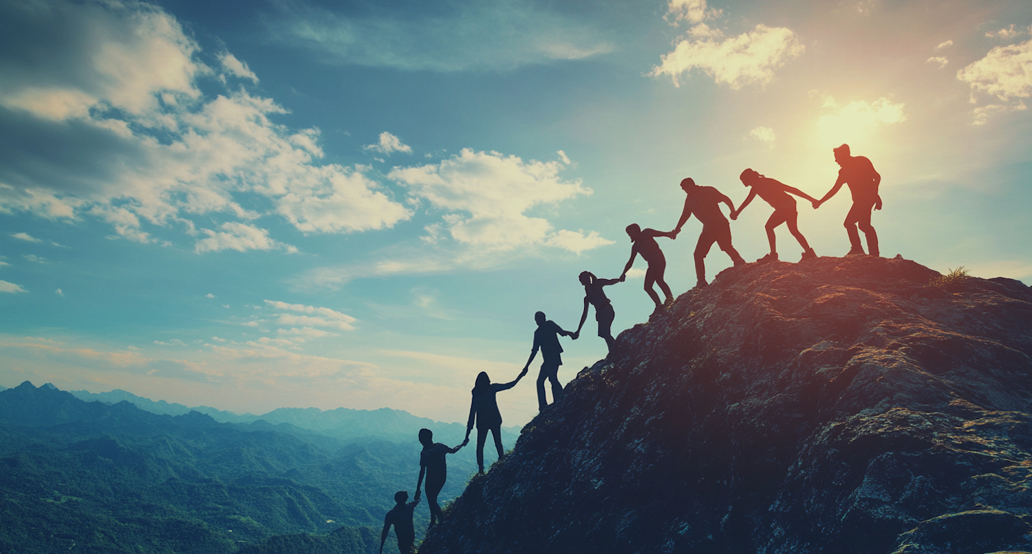 A group of diverse people working together to overcome a physical or emotional challenge, symbolizing resilience and shared struggle.