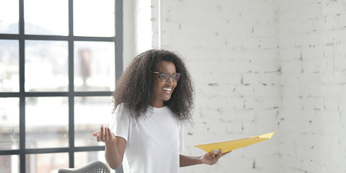 A confident individual presenting an idea, symbolizing the unexpected success of a project or person that defies initial doubts.