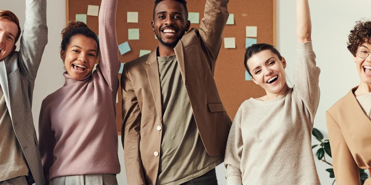A diverse team celebrating a hard-won success, embodying the spirit of an underdog triumphing against odds.