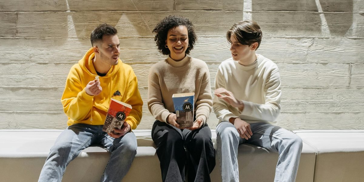 A group of friends engaged in an animated discussion about their favorite movies or series.