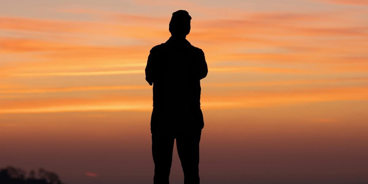 A person looking forward with determination and hope for a fresh start or new opportunity.