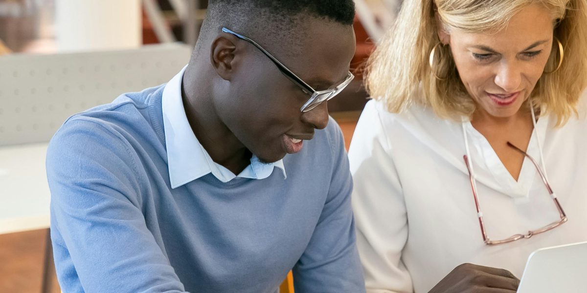 An experienced mentor offering guidance and support to a young adult, fostering growth and direction.
