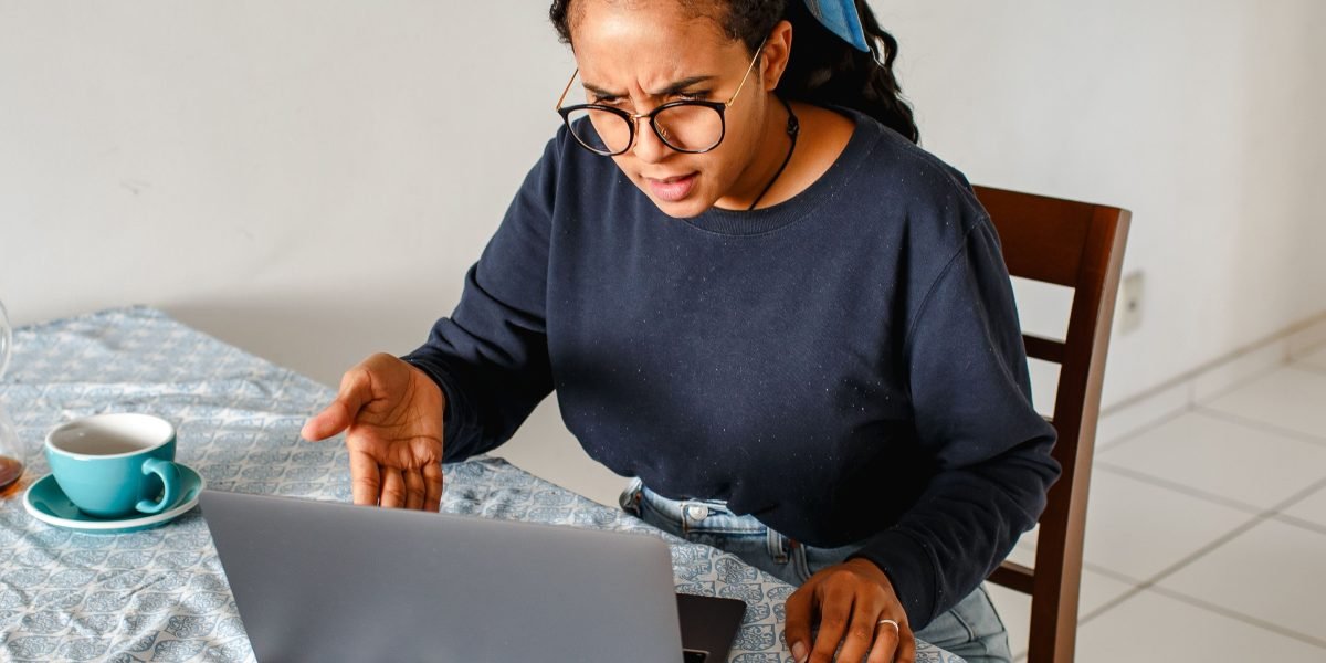 A person looking bored while scrolling through streaming services, unable to find anything appealing.